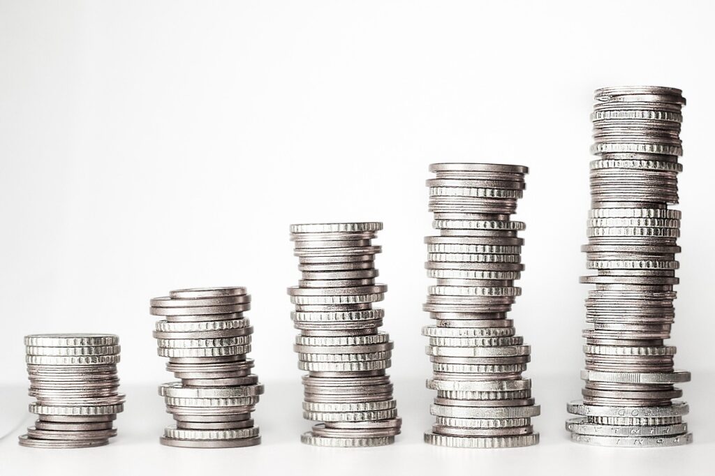 Stacks of coins growing taller, representing steady monthly investing