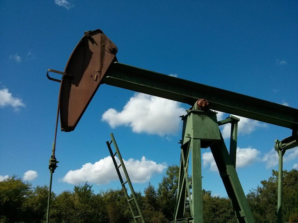 An oil pump jack silhouetted at sunset, representing oil price swings from Middle East tension