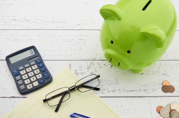 A piggy bank with coins, symbolizing money saved inside a tax-friendly ISA account