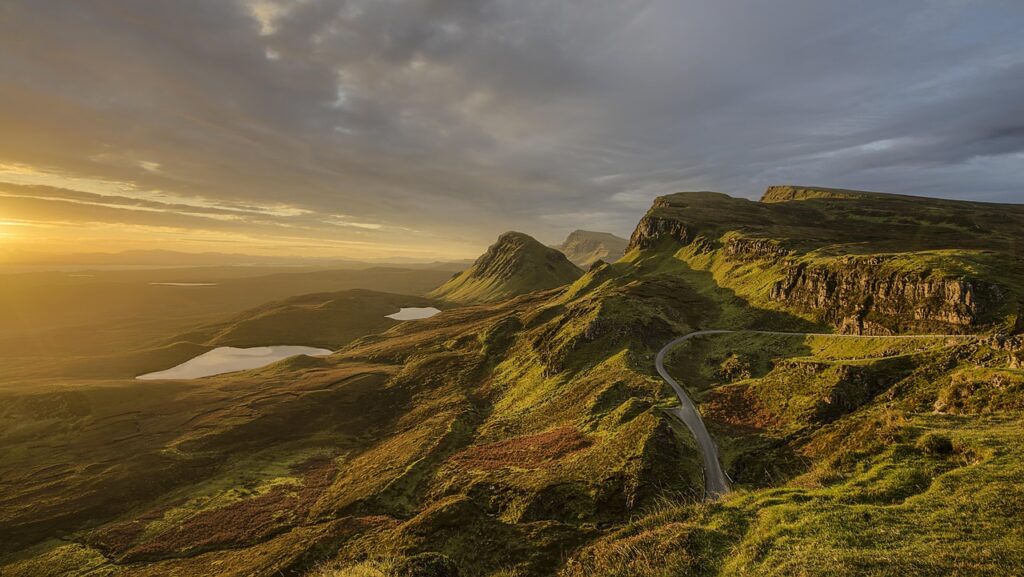 A winding mountain road at sunset, symbolizing the slow and steady long-term investing journey.
