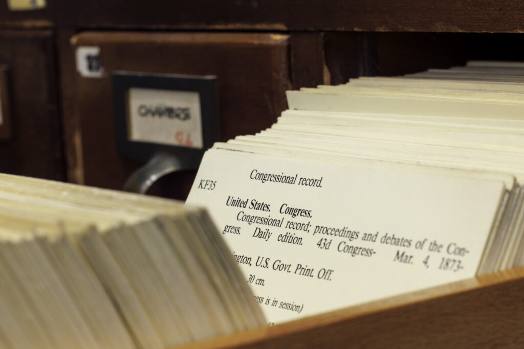 Rows of wooden card catalog drawers in a library, representing an orderly index rather than picking a single item